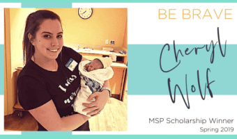 scholarship winner, cheryl wolf, holding a newborn baby