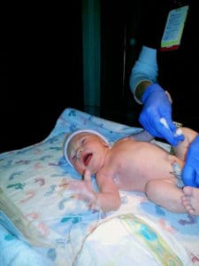 newborn baby being cleaned after birth